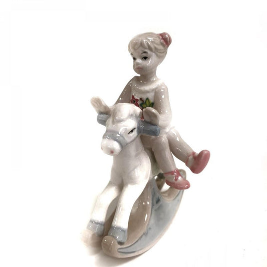 Girl Sitting On A Rocking Horse Figurine