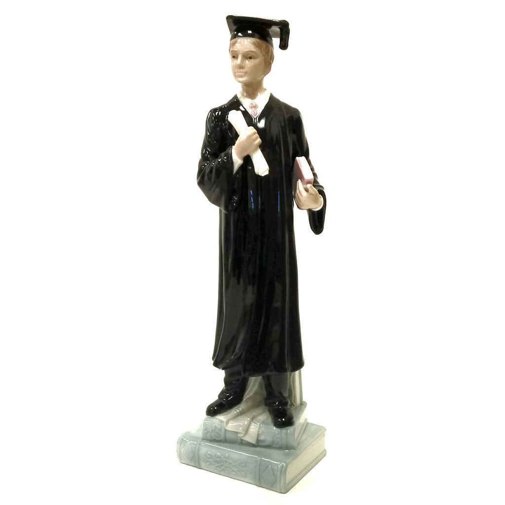 Male Graduate Holding A Diploma And Book Standing On Books Figurine