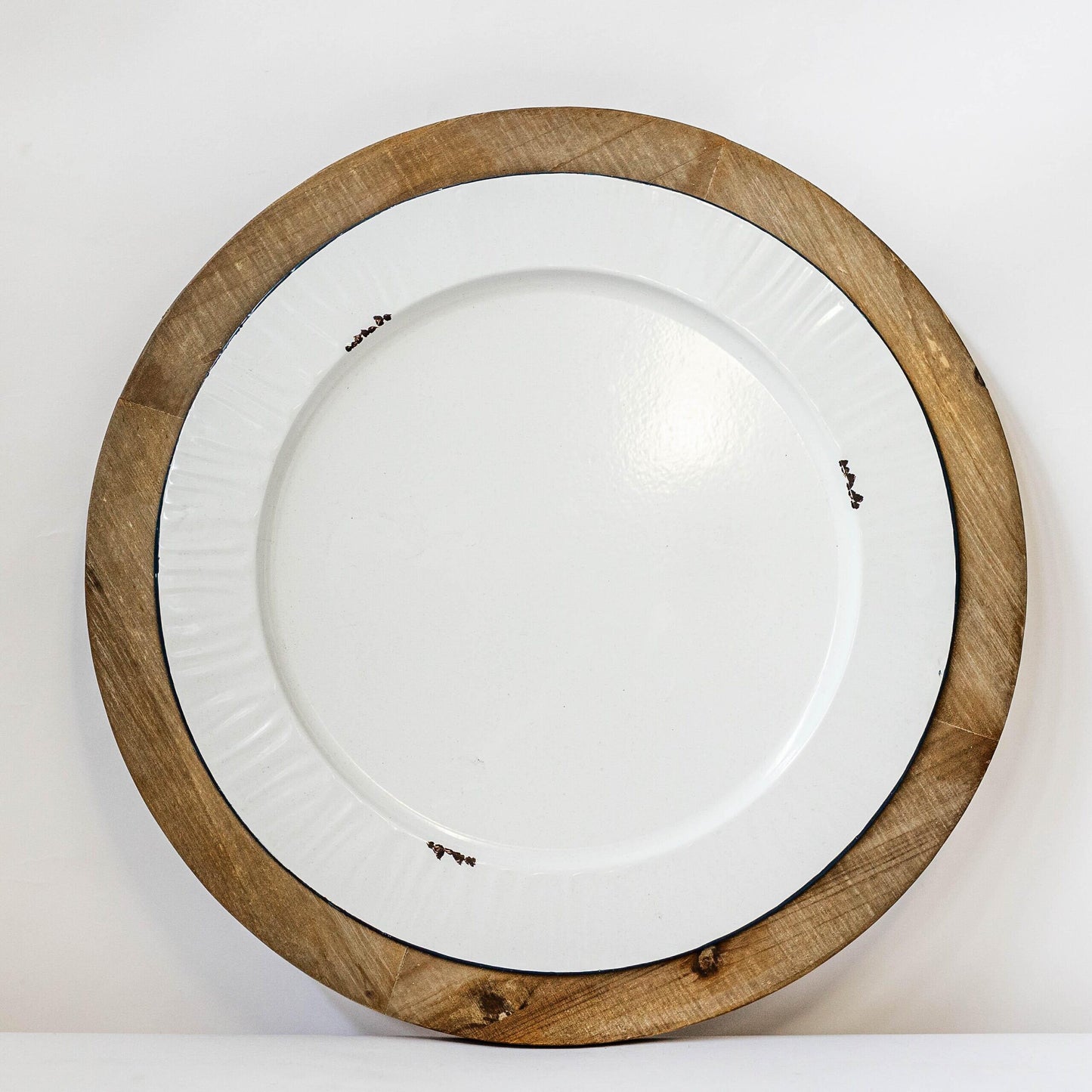 White Metal Plate In A Round Brown Built In Tray